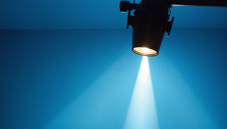 Spotlight in a blue room with a beam of light passing throughの素材