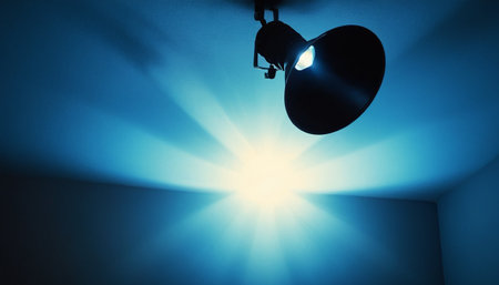 Lighting equipment in the dark room with rays of light coming from aboveの素材