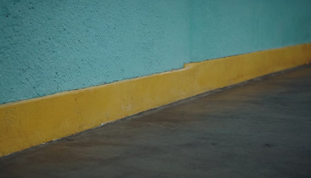 Blue and yellow wall with cement floor and cement floor in the backgroundの素材