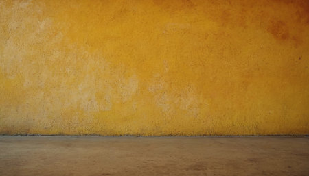 Old grunge yellow wall with concrete floor. Abstract background for design.の素材