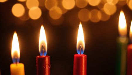 Burning candles on a dark background with bokeh effect.の素材
