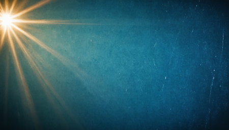 sunset over blue grunge background with sun rays and copy spaceの素材