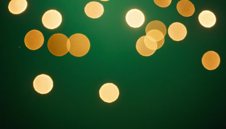 Golden bokeh lights on green background. Festive background.の素材