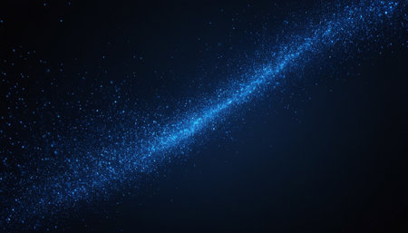 Abstract blue glittering star dust trail on a dark background. Vector illustrationの素材