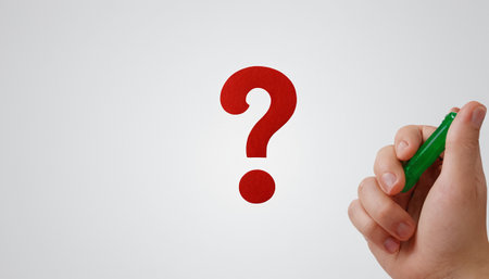 Female hand drawing question mark on white background. Question mark concept.の素材
