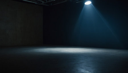 Empty room with spotlights and concrete floor. Stage illuminated by the spotlight.の素材