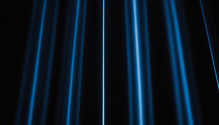 abstract background of blue rays of light on a black background.の素材