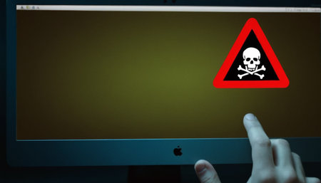 Computer screen with warning sign and skull on it. Cybercrime conceptの素材