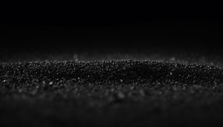 Black sand on a black background. Black sand texture. Abstract background.の素材