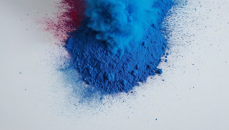 Blue and red powder explosion isolated on white background. Colorful dust cloud.の素材