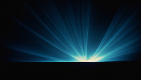 blue rays of light on a black background with space for text.の素材
