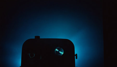 Old movie projector on a dark blue background. Close-up.の素材