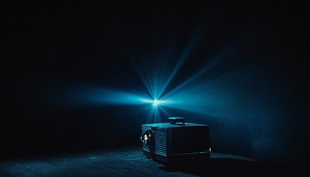 Vintage film projector on dark toned foggy background. Retro cinema concept. Selective focusの素材