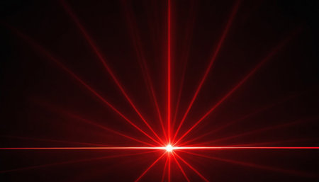 Red light lens flare effect on black background. Abstract design element.の素材