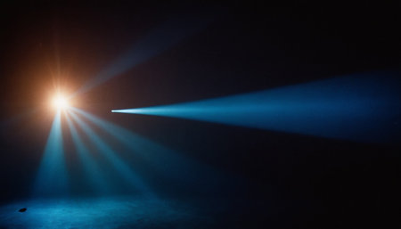 Blue light from the spotlights on a dark background with smoke and fogの素材