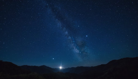 Milky way and stars in the night sky over the mountains.の素材