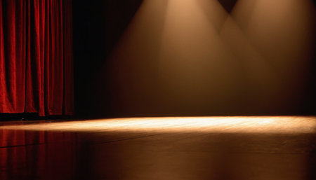 Stage with red curtain and spotlights in a theater or cinema.の素材