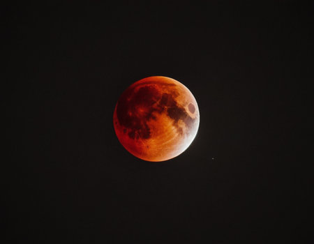 Bloody moon in the night sky, closeup of photo.の素材