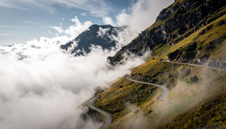Mountain road in the clouds. Beautiful landscape of Alps mountains.の素材