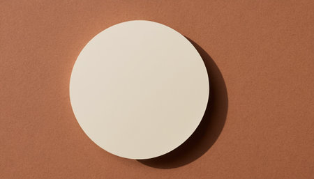 White round paper plate on brown background. Flat lay, top view.の素材