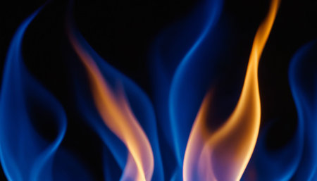 Fire flames on black background close-up. Abstract background for design.の素材