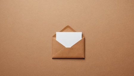 Envelope with blank paper sheet on brown background, top viewの素材