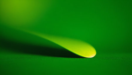 Close up of a water drop on a green background with copy spaceの素材