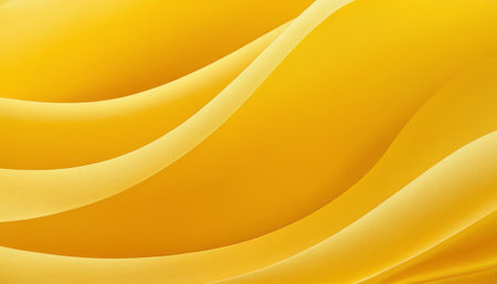 Abstract background of yellow wavy silk fabric. Close-up.の素材