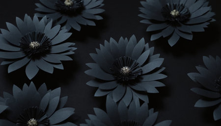 Black paper flowers on a black background. Flat lay, top view.の素材