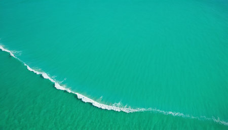 Aerial view of turquoise ocean with waves and white foamの素材