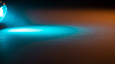 Close-up of a blue led light on a black background.の素材