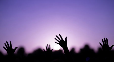 Silhouette of a crowd at a music festival with hands upの素材