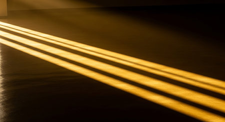 Light and shadow on the floor of an empty room with a dark backgroundの素材
