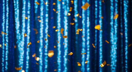 Golden confetti on a blue background. Festive background with bokeh.の素材
