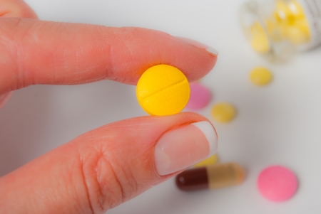 Yellow tablet in the handの写真素材