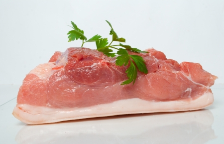 Piece of raw pork on white backgroundの写真素材