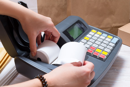Woman working with Electronic Cash Registerの写真素材