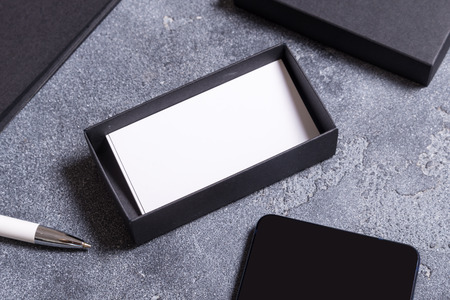 Black carton box and white business cards on office desk
