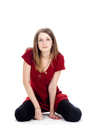 A serious woman in a red sweater. Looking straight at youの写真素材