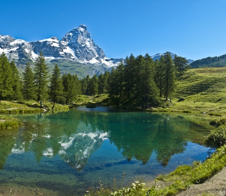 the Matterhorn reflected in the clear waters of blue lake, Valtournenche - Aosta Valleyの写真素材