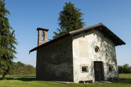 old church on the green grass and blue sky backgroundの写真素材
