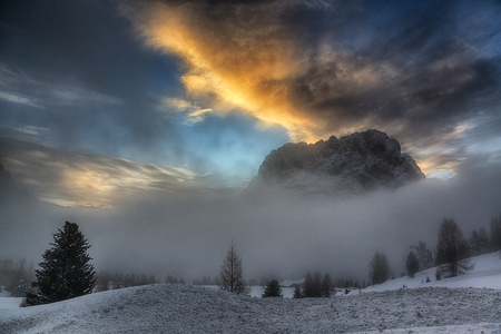 misty hills and sunset over the dolomitesの写真素材