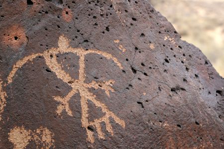 A petroglyph of a thunderbird pecked into a volcanic stone in New Mexicoの写真素材