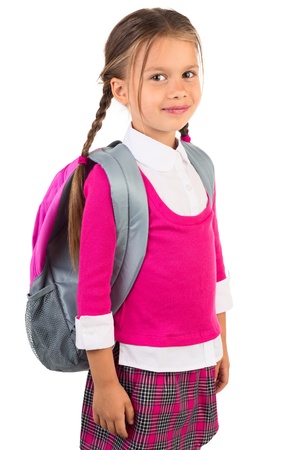 Beautiful little girl in pink school uniform and a backpack, isolatedの写真素材