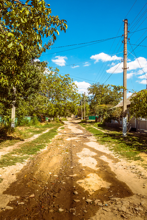 An unpawed street in a remote old village in eastern europeの写真素材