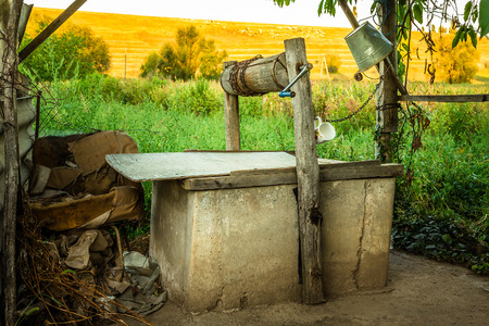Old shabby well in a rural area somewhere in Eastern Europeの写真素材