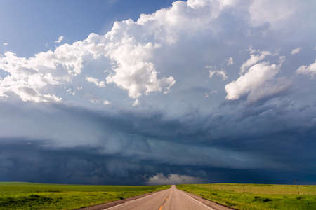 Dramatic storm clouds over a road