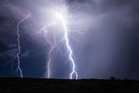 Lightning bolts strike in a stormの写真素材
