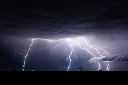 Thunderstorm lightning bolt strikes in the night sky