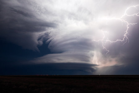 Supercell thunderstorm with dramatic stormy sky and lightning.
